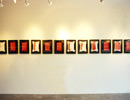 Wide shot of the exhibition showing 12 beaded Indian Act pages